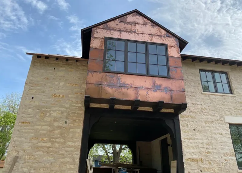 Copper metal panel facade on a stone building for Skylight Installation in South Salt Lake