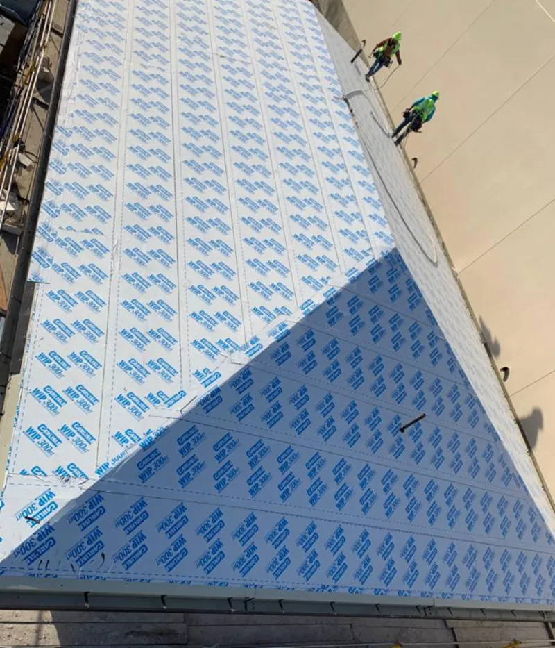 Professional roofers installing underlayment on a metal roof in South Salt Lake